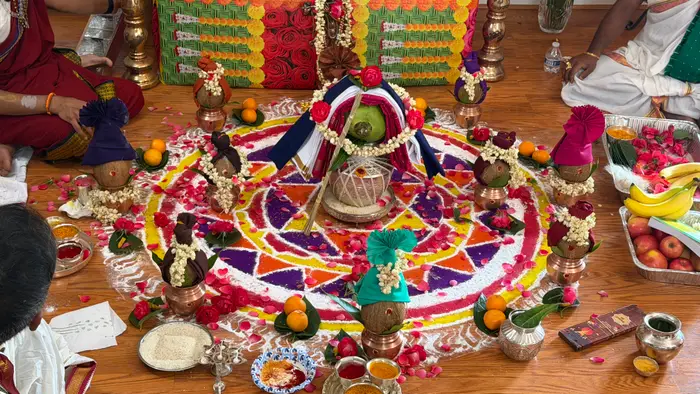 Overhead view of kalashams around a colored-rice mandala